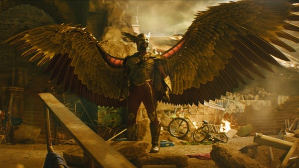 Hawkman posing with destruction around him.